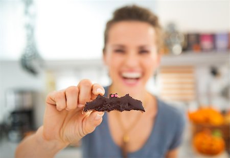 simsearch:400-08336563,k - Closeup on Halloween biscuit in shape of bat for Trick or Treat in hand of smiling young woman. Ready to halloween party. Traditional autumn holiday Stock Photo - Budget Royalty-Free & Subscription, Code: 400-08337744