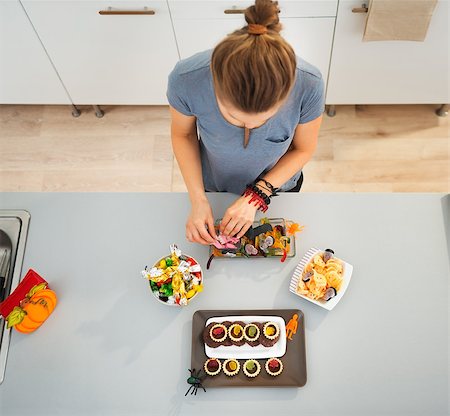 Woman in kitchen preparing horribly tasty treats for halloween party. Ready to halloween party! Traditional autumn holiday Stock Photo - Budget Royalty-Free & Subscription, Code: 400-08338091