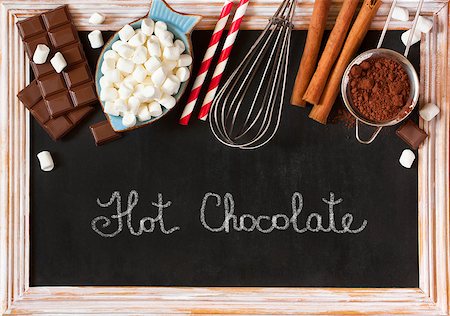 simsearch:400-08338397,k - Hot chocolate mix on old chalk blackboard. Sweet marshmallow, chocolate bars, sugar, cocoa powder, cinnamon, and whisk for cooking winter holiday drink. Photographie de stock - Aubaine LD & Abonnement, Code: 400-08338410