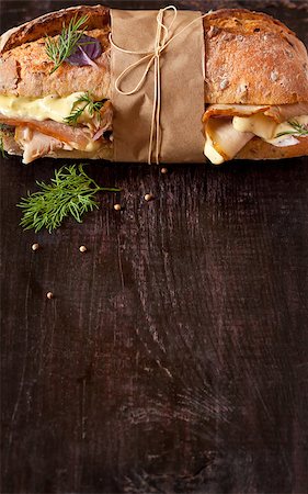 sliced ​​ham - Delicious meat sandwich wrapped in paper with kitchen twine on wood background with copy space for text. Stock Photo - Budget Royalty-Free & Subscription, Code: 400-08338432