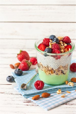 Healthy breakfast. Homemade granola, chia seeds yogurt and fresh berries in glass jar. Stock Photo - Budget Royalty-Free & Subscription, Code: 400-08338458