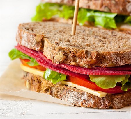sandwich rustic table - Delicious sausage sandwich with wholegrain bread closeup. Foto de stock - Super Valor sin royalties y Suscripción, Código: 400-08338484
