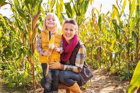 Portrait of happy mother and child staying in corn field on farm on sunny autumn day Stock Photo - Budget Royalty-Free & Subscription, Code: 400-08339784