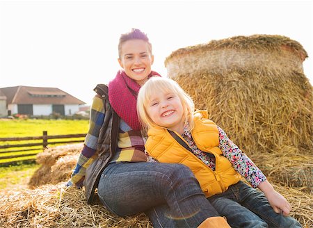 simsearch:400-07916492,k - Portrait of beautiful smiling woman and cute girl sitting on the hay on farm and having fun together Stock Photo - Budget Royalty-Free & Subscription, Code: 400-08339780