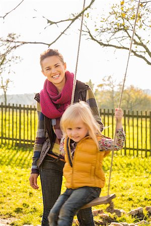 simsearch:400-07916492,k - Portrait of smiling woman and swinging child on beautiful sunny autumn day on farm Stock Photo - Budget Royalty-Free & Subscription, Code: 400-08339793