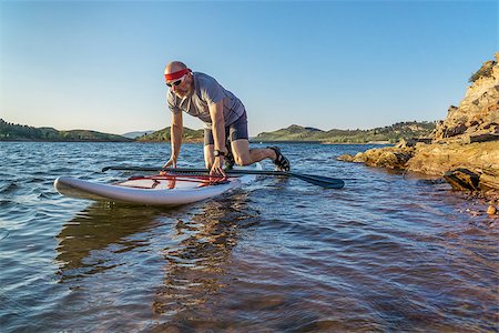 simsearch:400-07795226,k - male paddler starting stand up paddling on a rocky shore of Horsetooth Reservoir, Fort Collins, Colorado, summer scenery Foto de stock - Royalty-Free Super Valor e Assinatura, Número: 400-08332888