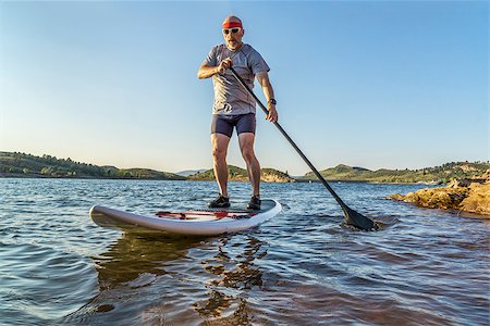 simsearch:400-07795226,k - senior male paddler enjoying stand up paddling on a sunny summer day - Horsetooth Reservoir, Fort Collins, Colorado Foto de stock - Royalty-Free Super Valor e Assinatura, Número: 400-08332889