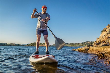 simsearch:400-07795226,k - senior male paddler enjoying stand up paddling on a sunny summer day - Horsetooth Reservoir, Fort Collins, Colorado Foto de stock - Royalty-Free Super Valor e Assinatura, Número: 400-08332968