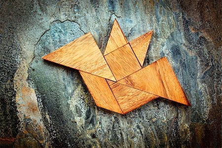 simsearch:400-07774007,k - abstract picture of a flying bat built from seven tangram wooden pieces over a slate rock background, Halloween concept, artwork created by the photographer Foto de stock - Royalty-Free Super Valor e Assinatura, Número: 400-08332969