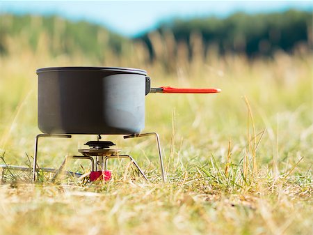 Can with water on portable camping stove Stock Photo - Budget Royalty-Free & Subscription, Code: 400-08332998