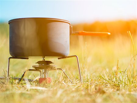 stove heat cook pot water - Can with water on portable camping stove Stock Photo - Budget Royalty-Free & Subscription, Code: 400-08332999