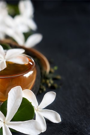 Cup of jasmine tea with bamboo scoop and blossom. Copy space background. Stock Photo - Budget Royalty-Free & Subscription, Code: 400-08333011