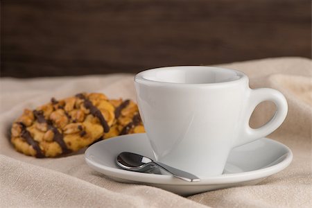 pouring cappuccino - White coffee cup with coffee and around the cup lies some delicious cookies. Foto de stock - Super Valor sin royalties y Suscripción, Código: 400-08333337