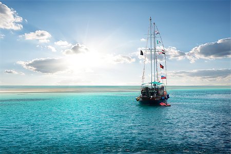 Yacht in the sea near island at sunrise Stock Photo - Budget Royalty-Free & Subscription, Code: 400-08333394