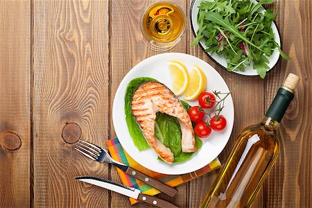 salmon steak on bbq - Grilled salmon and white wine on wooden table. Top view with copy space Stock Photo - Budget Royalty-Free & Subscription, Code: 400-08344224