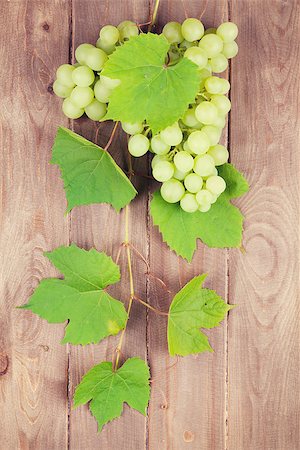 simsearch:400-08110621,k - Bunch of white grapes with leaves on wooden background Stock Photo - Budget Royalty-Free & Subscription, Code: 400-08344283