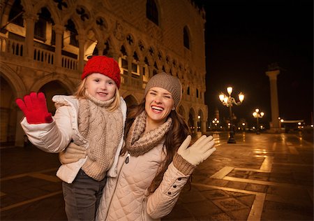 Holiday family trip to Venice, Italy can change the whole Christmas experience. Portrait of happy mother and child handwaving on Piazza San Marco in the evening. Winter Tourism Stock Photo - Budget Royalty-Free & Subscription, Code: 400-08344329