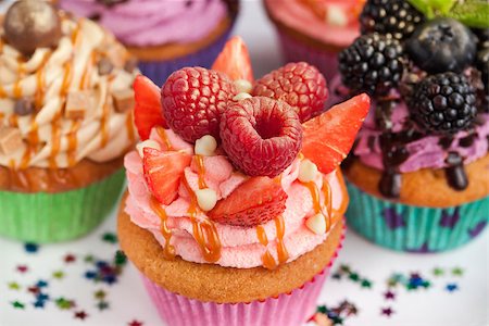 Delicious pink cupcake decorated with raspberry and strawberry Stock Photo - Budget Royalty-Free & Subscription, Code: 400-08344393