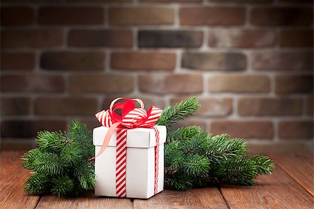 Christmas gift box and fir tree branch on wooden table Stock Photo - Budget Royalty-Free & Subscription, Code: 400-08346930