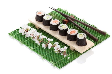 simsearch:400-08072780,k - Sushi maki set with salmon and cucumber and sakura branch. Isolated on white background Photographie de stock - Aubaine LD & Abonnement, Code: 400-08346978