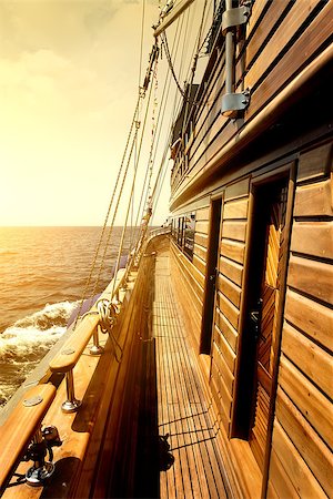 simsearch:400-05069088,k - Wooden sailboat in sea at the bright sunrise Stockbilder - Microstock & Abonnement, Bildnummer: 400-08340279