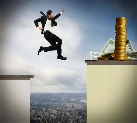 Determined businessman jumps risky to get money Stock Photo - Budget Royalty-Free & Subscription, Code: 400-08340445
