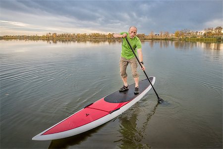 senior male paddler on a paddleboard, lake in Colorado with a fall scenery and dark clouds Stock Photo - Budget Royalty-Free & Subscription, Code: 400-08341769