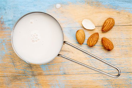 simsearch:400-08342479,k - almond milk in measuring cup with almond nuts against wooden background Stock Photo - Budget Royalty-Free & Subscription, Code: 400-08341763