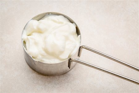 simsearch:400-08342479,k - metal measuring cup of Greek yogurt against ceramic tile Stock Photo - Budget Royalty-Free & Subscription, Code: 400-08342099