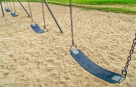 sandbox - a row of empty swings in a playground with sand Stock Photo - Budget Royalty-Free & Subscription, Code: 400-08342108