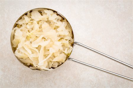 simsearch:400-08339036,k - top view of metal measuring scoop of sauerkraut against ceramic tile - healthy eating concept (probiotic food) Stock Photo - Budget Royalty-Free & Subscription, Code: 400-08342479