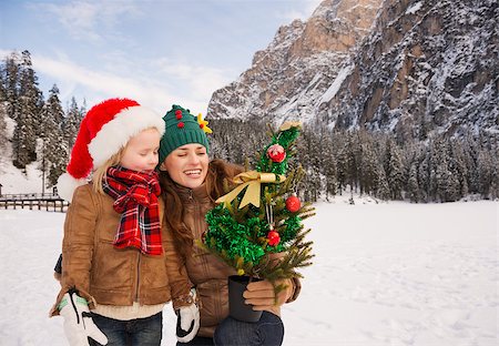 simsearch:400-08054005,k - Winter outdoors on Christmas can be fairytale-maker for a children or even an adults. Happy mother and child looking on Christmas tree in the front of mountains Stock Photo - Budget Royalty-Free & Subscription, Code: 400-08342575