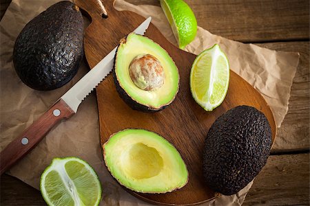 simsearch:400-04395073,k - Sliced fresh avocado and lemon lime on cutting board, on wooden background Stock Photo - Budget Royalty-Free & Subscription, Code: 400-08342645