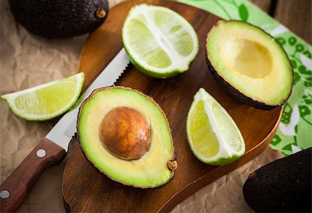 simsearch:400-04395073,k - Sliced fresh avocado and lemon lime on cutting board, on wooden background Stock Photo - Budget Royalty-Free & Subscription, Code: 400-08342647