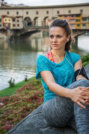 Young sporty female relaxing in front of Ponte Vecchio and listening music on mp3 player in Florence, Italy Stock Photo - Budget Royalty-Free & Subscription, Code: 400-08342859