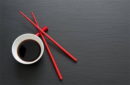 Soy sauce with red chopsticks on black slate table Stock Photo - Budget Royalty-Free & Subscription, Code: 400-08342943