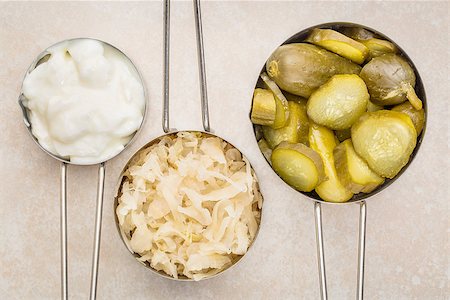 simsearch:400-08342479,k - sauerkraut, cucumber pickles and yogurt - popular probiotic fermented food - three measuring cups against ceramic tile Stock Photo - Budget Royalty-Free & Subscription, Code: 400-08343082