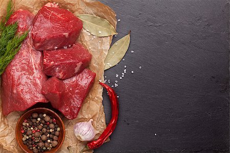 steak on paper - Raw fillet beef steak and spices on stone board. Top view with copy space Stock Photo - Budget Royalty-Free & Subscription, Code: 400-08343121