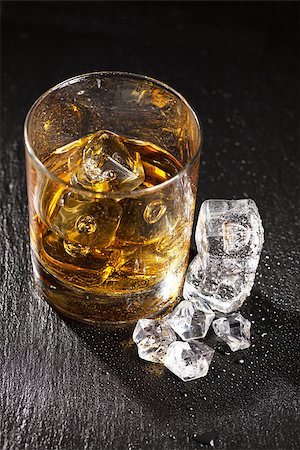 simsearch:622-08138985,k - Glass of whiskey with ice on black stone table Stock Photo - Budget Royalty-Free & Subscription, Code: 400-08343145