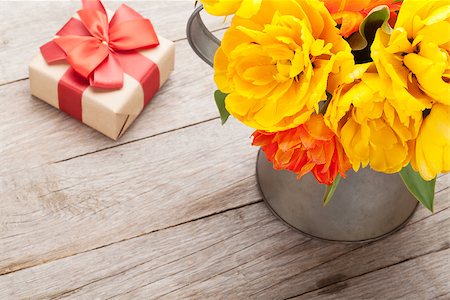 simsearch:400-08036453,k - Colorful tulips bouquet and gift box over wooden table background Stock Photo - Budget Royalty-Free & Subscription, Code: 400-08343148