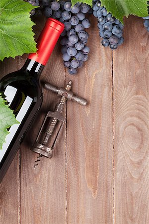 simsearch:400-08110621,k - Red grape, wine bottle and vintage corkscrew on wooden table. Top view with copy space Stock Photo - Budget Royalty-Free & Subscription, Code: 400-08343194