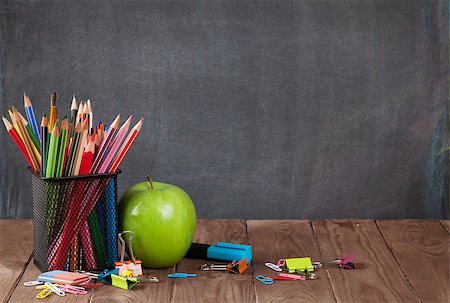 simsearch:400-04834843,k - School and office supplies on classroom table in front of blackboard. View with copy space Stock Photo - Budget Royalty-Free & Subscription, Code: 400-08343192