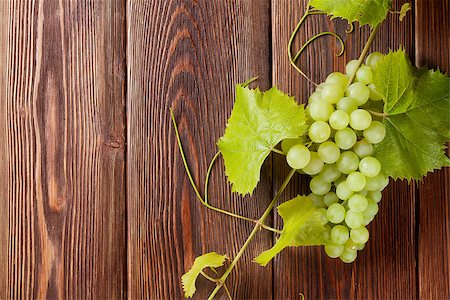 simsearch:400-08110621,k - Bunch of white grapes with leaves on wooden background with copy space Stock Photo - Budget Royalty-Free & Subscription, Code: 400-08343211