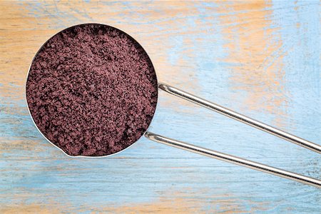 acai berry powder on a metal measuring scoop against painted grunge wood Stock Photo - Budget Royalty-Free & Subscription, Code: 400-08343307