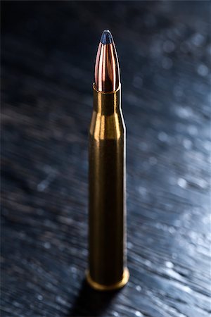 simsearch:400-08572725,k - Large-caliber cartridge on a dark background with reinforced shiny bullet with a lead tip. Photographed in the studio. Foto de stock - Super Valor sin royalties y Suscripción, Código: 400-08343828