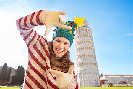 simsearch:400-08344334,k - Young, itching from energy and searching for excitement. I'm going to Christmas trip to Italy. It is a no-brainer. Happy woman in Christmas tree hat framing with hands in front of Leaning Tour of Pisa Stock Photo - Budget Royalty-Free & Subscription, Code: 400-08343865