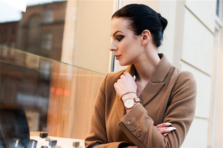 very cute brunette girl going for shop in a winter day . she is standing at the windoe shop Stock Photo - Budget Royalty-Free & Subscription, Code: 400-08376677