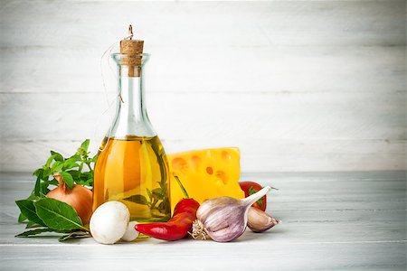 Olive oil with spices and vegetables on wooden board Stock Photo - Budget Royalty-Free & Subscription, Code: 400-08377738