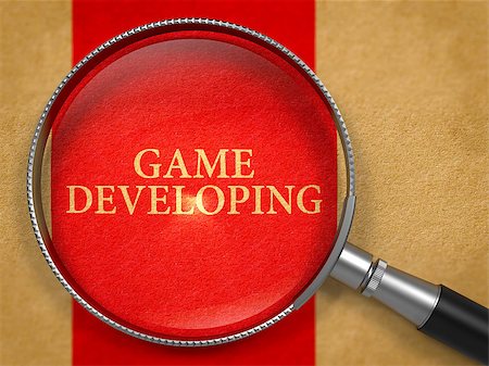 Game Developing through Loupe on Old Paper with Red Vertical Line Background. Stock Photo - Budget Royalty-Free & Subscription, Code: 400-08378800
