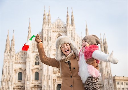 simsearch:400-08341864,k - Why not to hang out in Italian fashion capital Milan on winter holidays with family. Happy mother and daughter with Italian flag rejoicing in front of Duomo Fotografie stock - Microstock e Abbonamento, Codice: 400-08379462